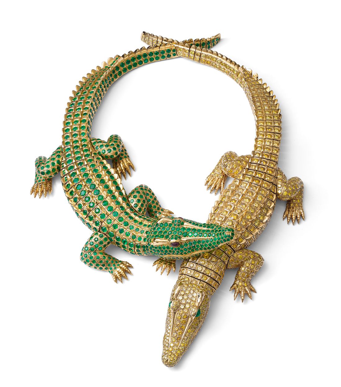 A necklace of two crocodiles, bedecked with jewels, one green and one golden, with the green crocoidile's head on the gold one's
